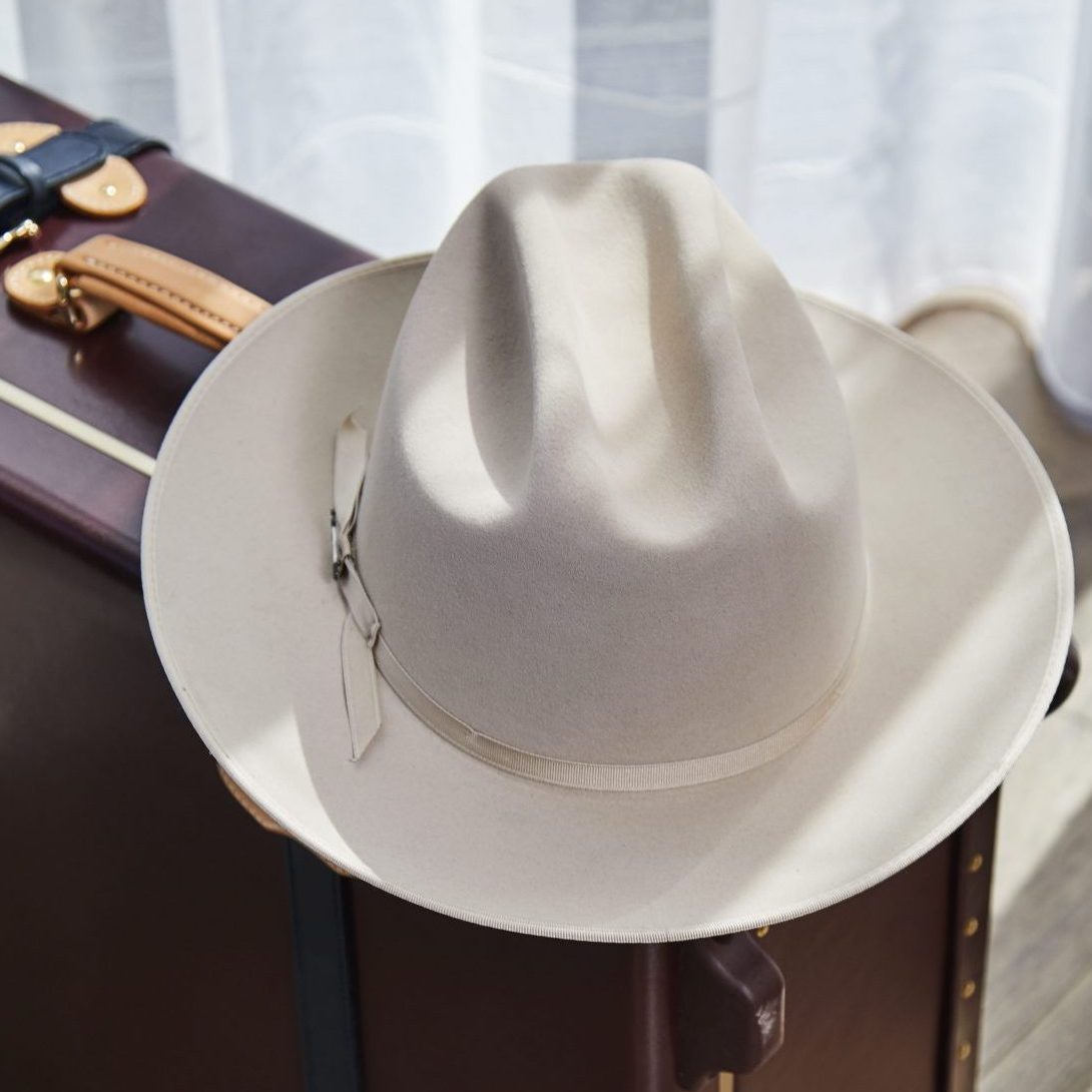 Signature Noelle Hat on Suitcase